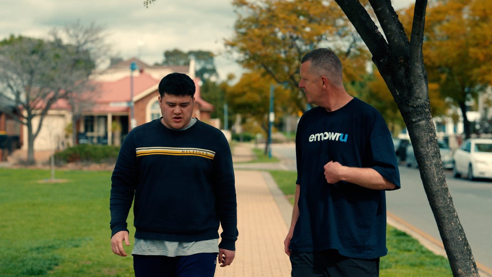 A participant talking with his EmpwrU mentor on a walk through the neighbourhood