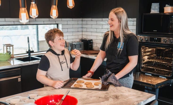 A participant baking with their EmpwrU mentor