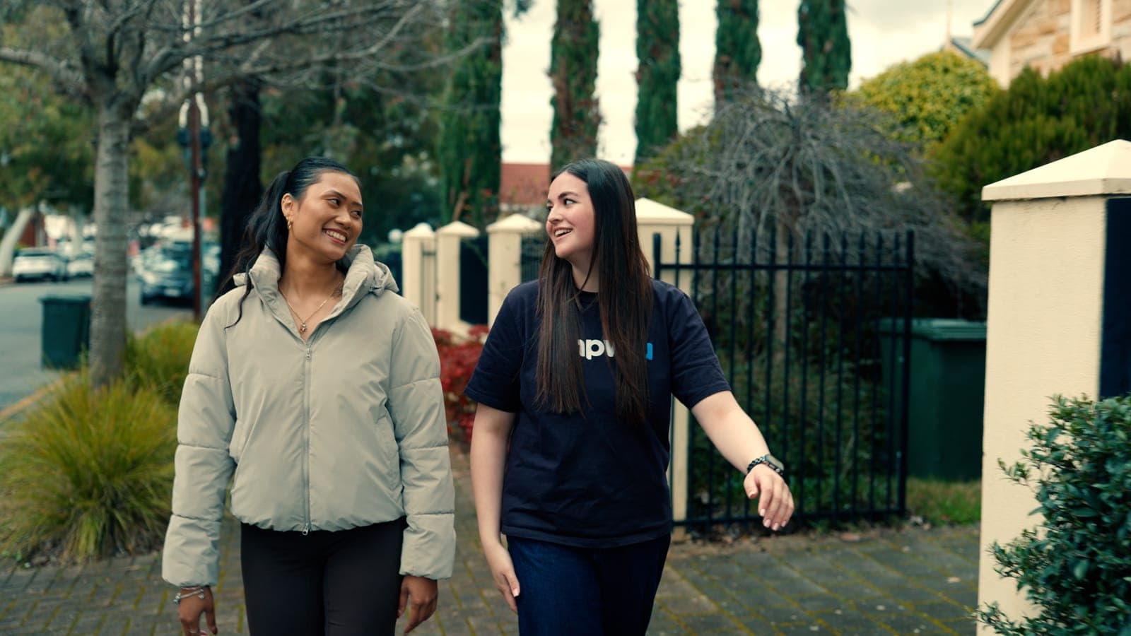 A participant and her EmpwrU support worker chatting on a walk