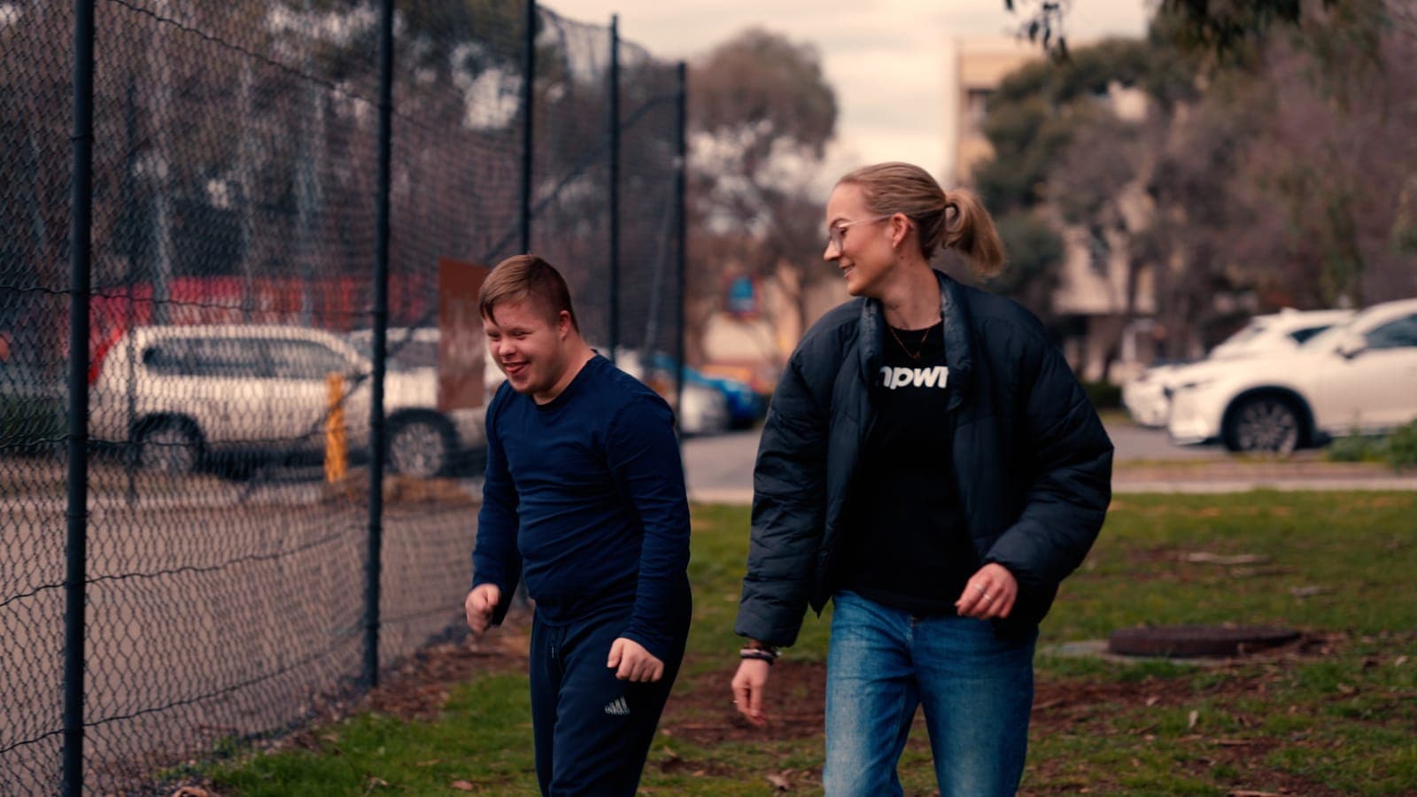 A participant and his EmpwrU support worker out walking together