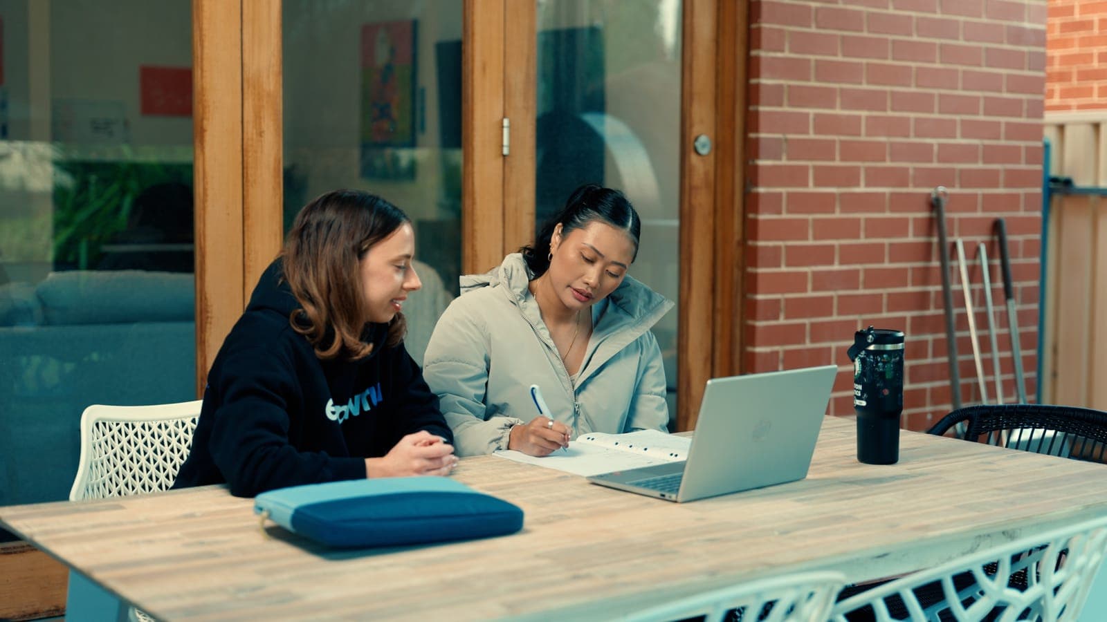 A participant working through her plan at a laptop with her EmpwrU support worker